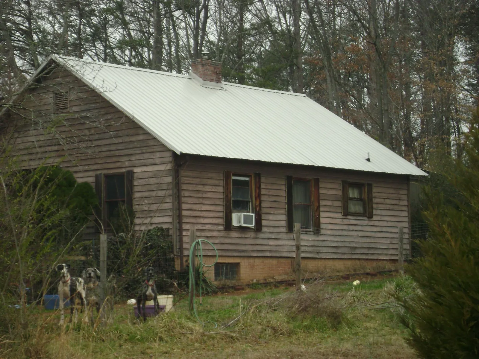 White metal roof on an old wood sided farmhouse, from a Metal Roof Installation job in Keuka Park